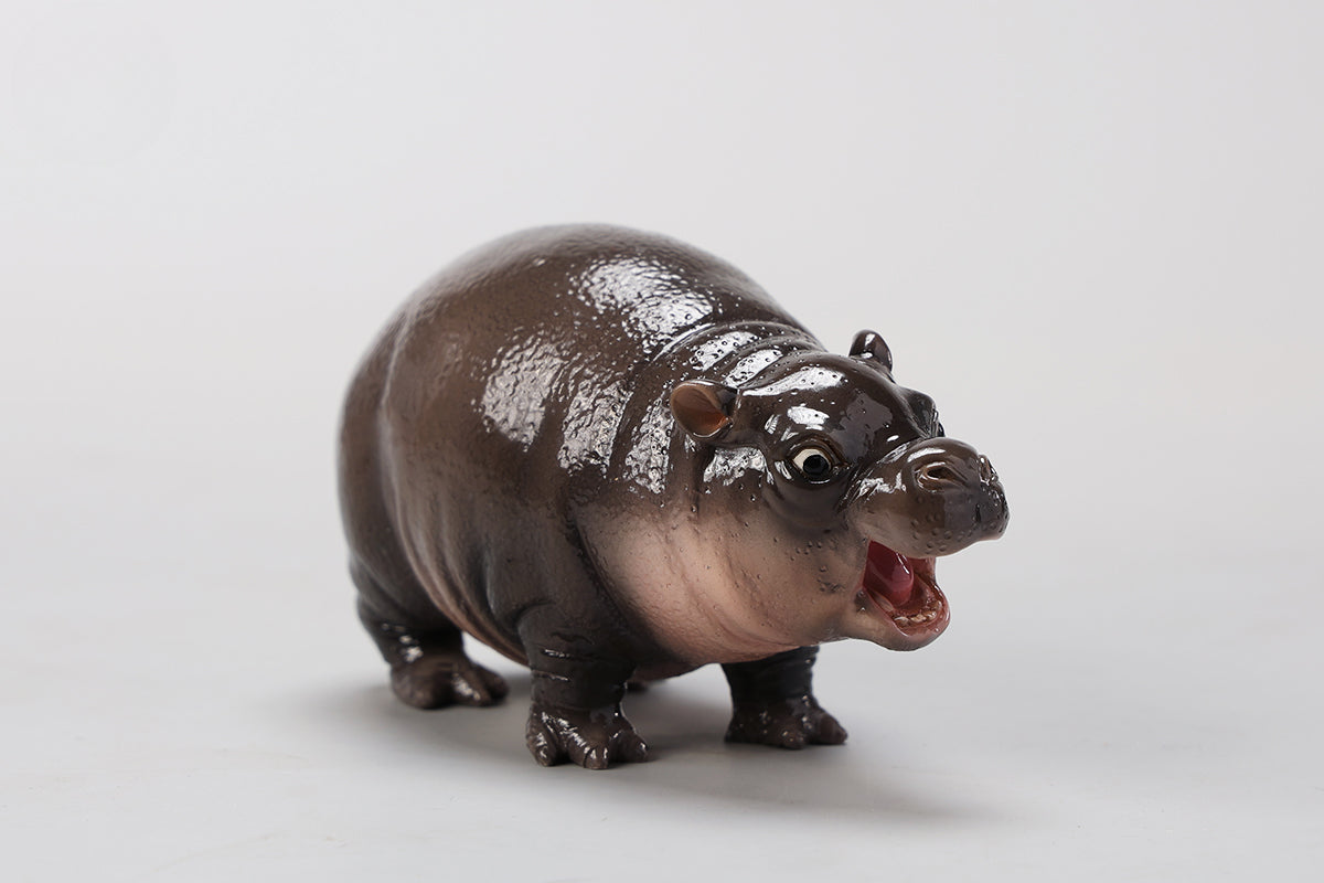 A cute 1/6 scale baby hippo figurine, hand-painted and made from high-quality resin. It features realistic details such as textured skin and a joyful expression, making it an ideal gift for animal lovers or a charming decor item for any room. Perfect for collectors of animal figurines.