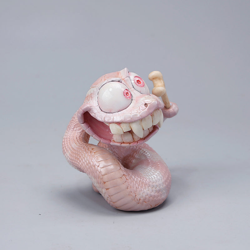 A highly detailed 1/6 scale Chinese Zodiac Snake Figurine featuring a pinkish snake with an exaggerated facial expression, sharp teeth, and a removable magnetic face. Made of resin, this artistic collectible includes intricate textures and craftsmanship, making it an ideal display piece for collectors and fantasy lovers.
