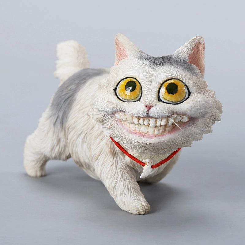 A highly detailed grinning cat resin figurine with expressive eyes, textured fur, and a wide smile. This unique decorative sculpture includes a bone pendant necklace and serves as a quirky, surreal home decor piece or collectible item for cat lovers and fantasy art fans.