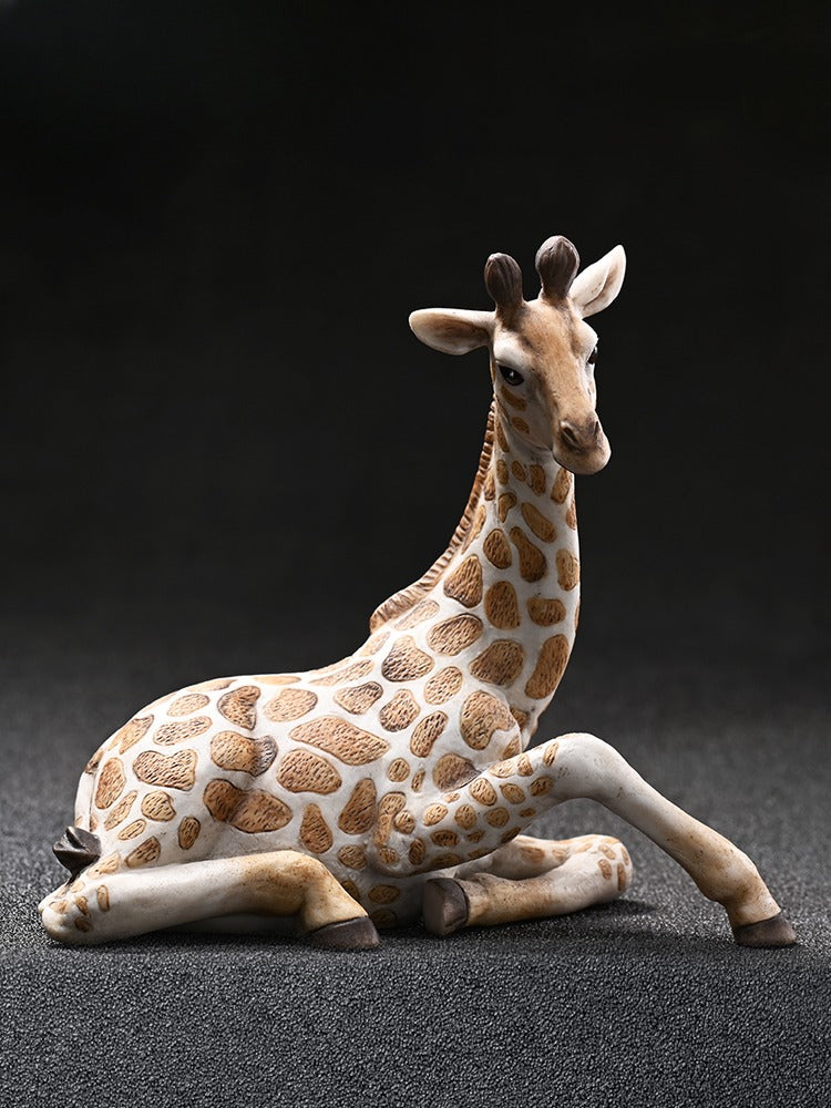 A realistic handcrafted giraffe figurine, made from high-quality resin. The giraffe is depicted with intricate hand-carved details and lifelike textures, standing at 11 cm tall. This figurine is an elegant decorative piece perfect for wildlife lovers and collectors.