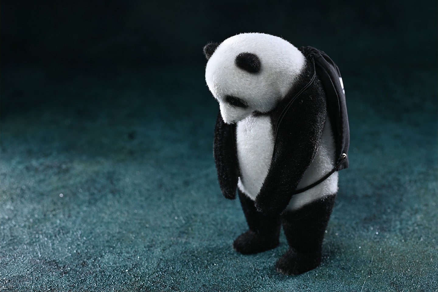 This adorable flocked panda figurine features a realistic texture, handcrafted details, and a soft-touch surface. It includes removable accessories like a bow tie, glasses, and a backpack, making it a customizable collectible. Made from high-quality resin, cloth, and metal, this panda sculpture is a perfect home decor piece or gift for panda lovers.