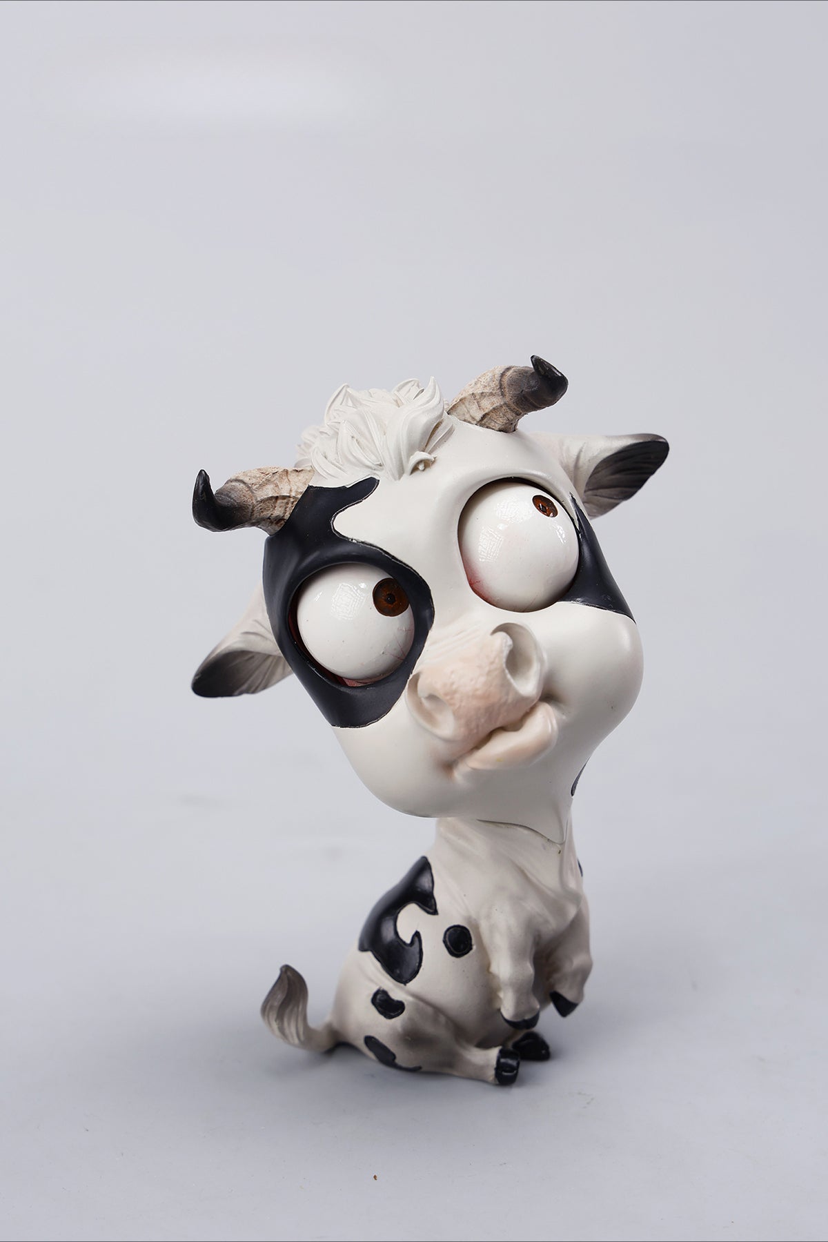 A detailed hand-painted ox figurine from the 12 Chinese Zodiac collection featuring a quirky removable face, premium resin material, and intricate artistic details. A perfect collector’s item and home decor piece for zodiac enthusiasts.