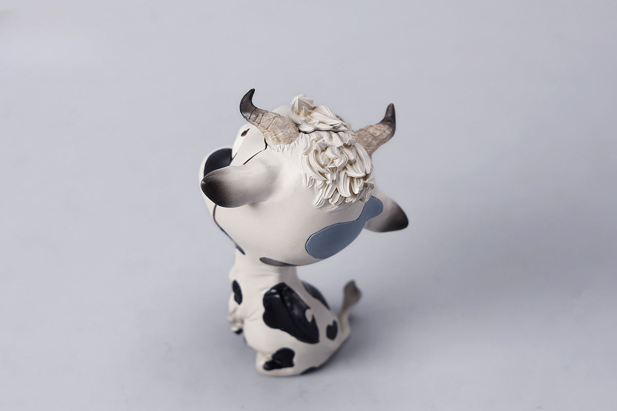 A detailed hand-painted ox figurine from the 12 Chinese Zodiac collection featuring a quirky removable face, premium resin material, and intricate artistic details. A perfect collector’s item and home decor piece for zodiac enthusiasts.