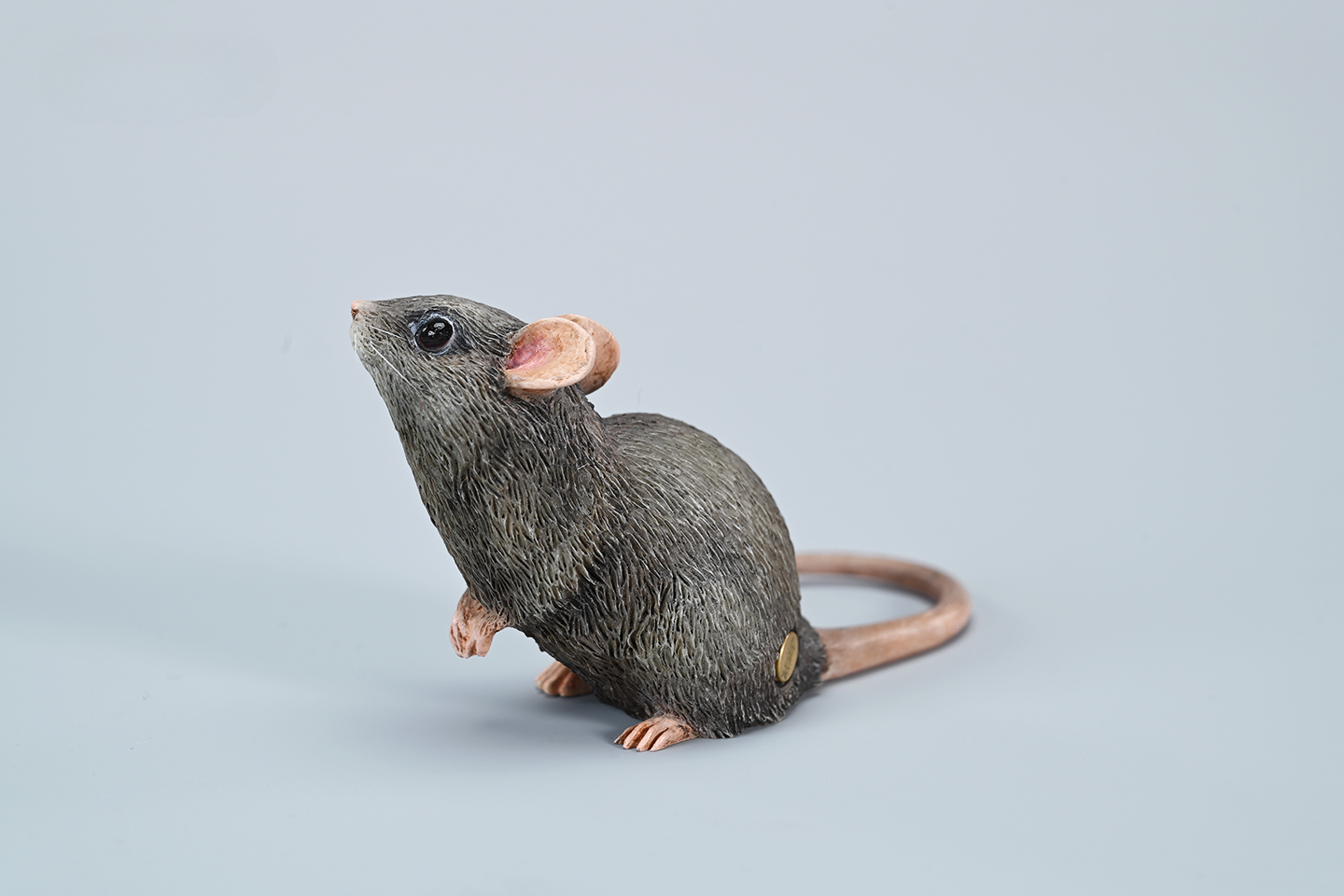 This image showcases a highly detailed, lifelike mouse figurine, part of the Pre-sale 1/1 Small Simulation Mouse Model collection. The model features a realistic depiction with intricate fur texture, expressive eyes, and delicate paws, highlighting its craftsmanship. The mouse is posed naturally, making it a perfect addition to any animal lover's collection.