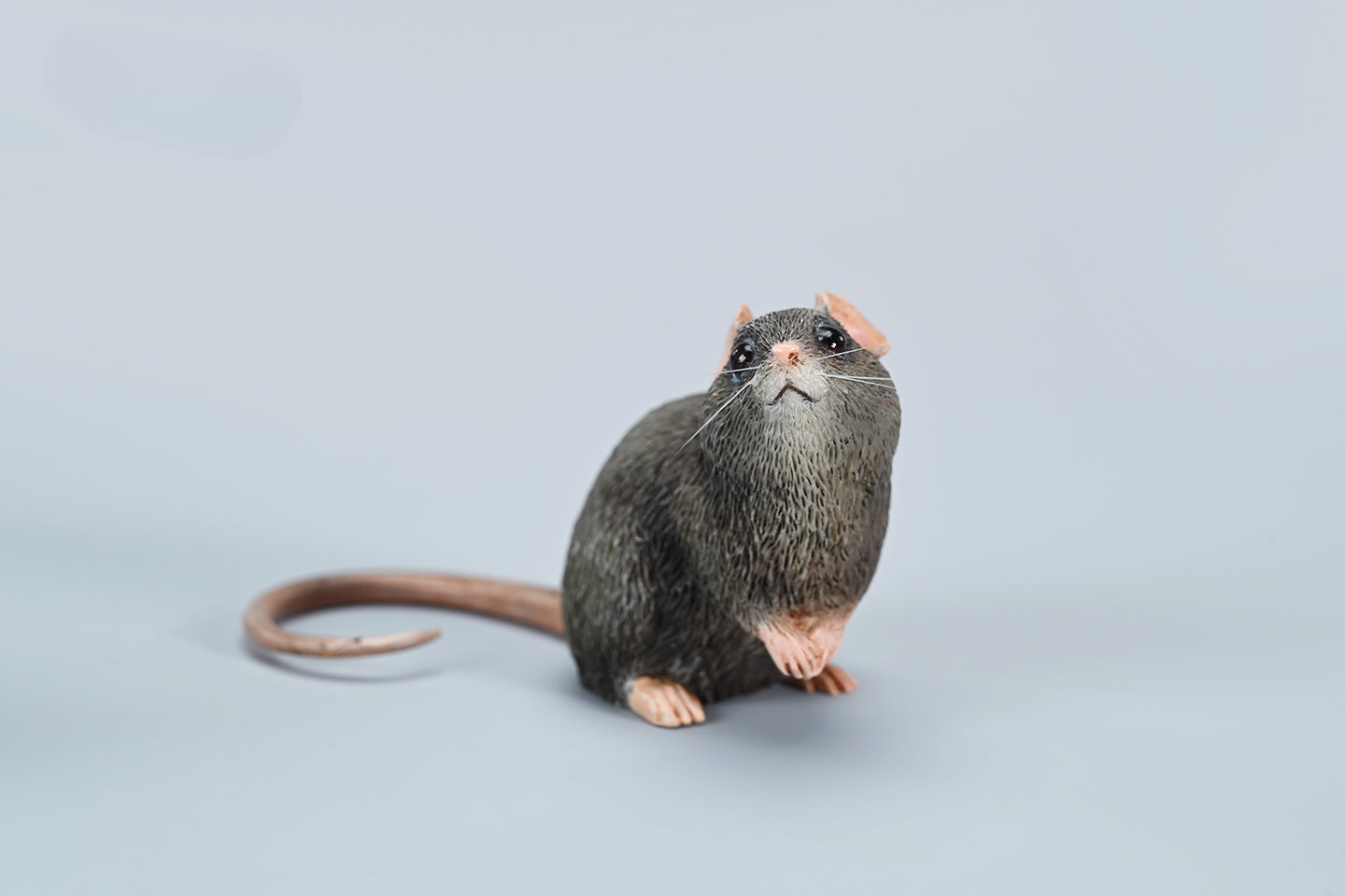 This image showcases a highly detailed, lifelike mouse figurine, part of the Pre-sale 1/1 Small Simulation Mouse Model collection. The model features a realistic depiction with intricate fur texture, expressive eyes, and delicate paws, highlighting its craftsmanship. The mouse is posed naturally, making it a perfect addition to any animal lover's collection.