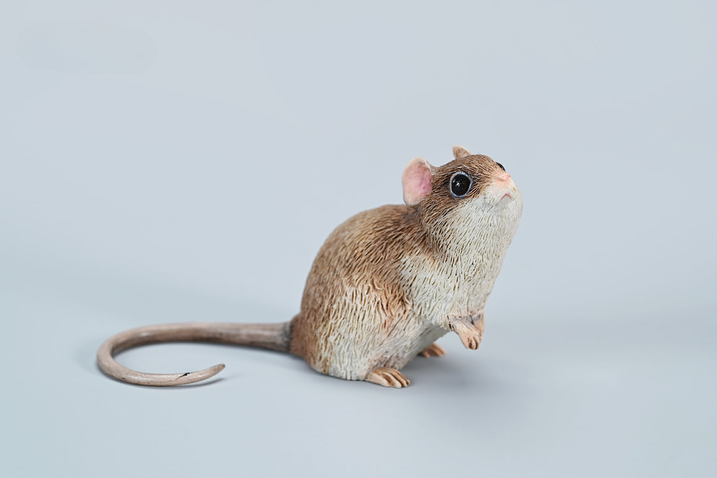 This image showcases a highly detailed, lifelike mouse figurine, part of the Pre-sale 1/1 Small Simulation Mouse Model collection. The model features a realistic depiction with intricate fur texture, expressive eyes, and delicate paws, highlighting its craftsmanship. The mouse is posed naturally, making it a perfect addition to any animal lover's collection.