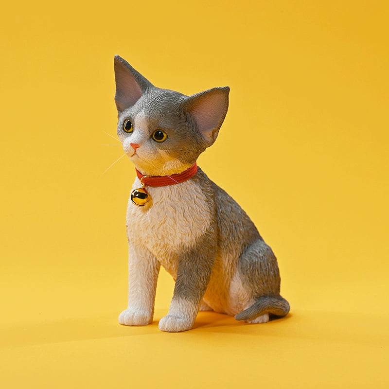 A set of 1/3 scale German Curly Cat resin models featuring five cats with distinct fur colors and patterns. The cats are shown sitting attentively around a pair of human legs, wearing red collars with bells. The scene is set against a yellow background.