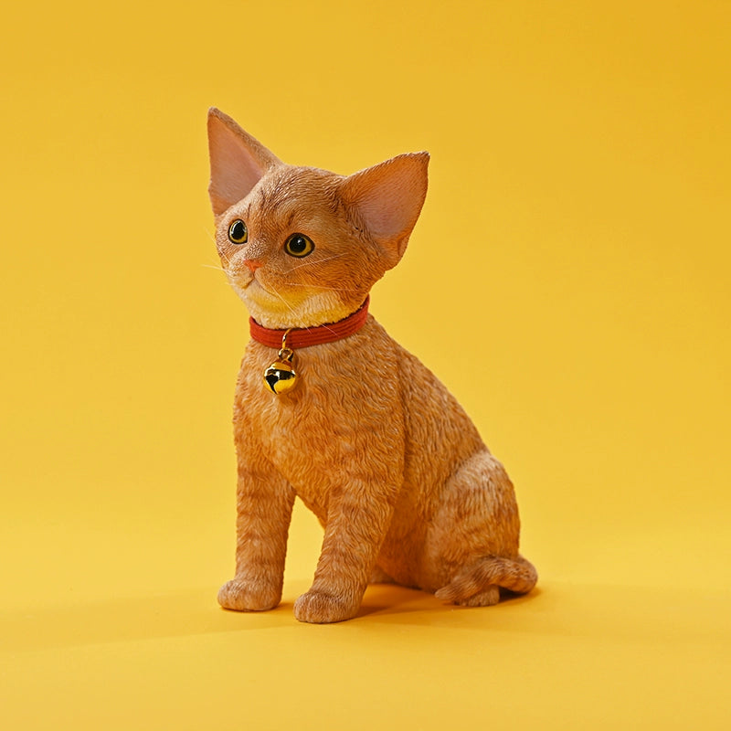 A set of 1/3 scale German Curly Cat resin models featuring five cats with distinct fur colors and patterns. The cats are shown sitting attentively around a pair of human legs, wearing red collars with bells. The scene is set against a yellow background.