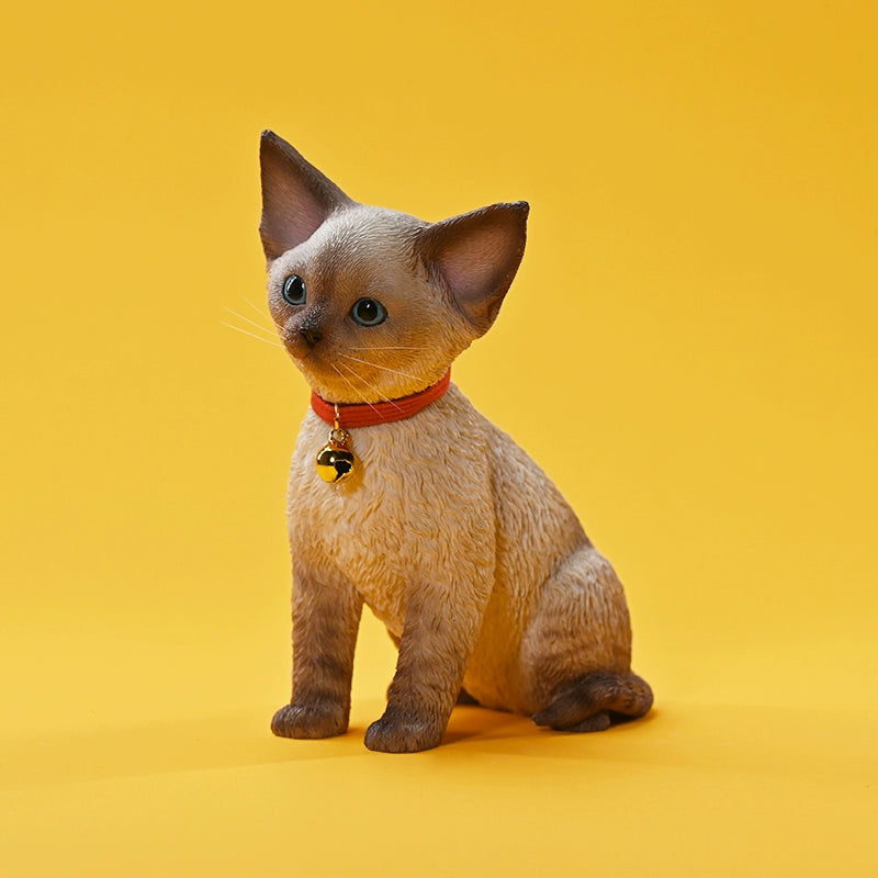 A set of 1/3 scale German Curly Cat resin models featuring five cats with distinct fur colors and patterns. The cats are shown sitting attentively around a pair of human legs, wearing red collars with bells. The scene is set against a yellow background.