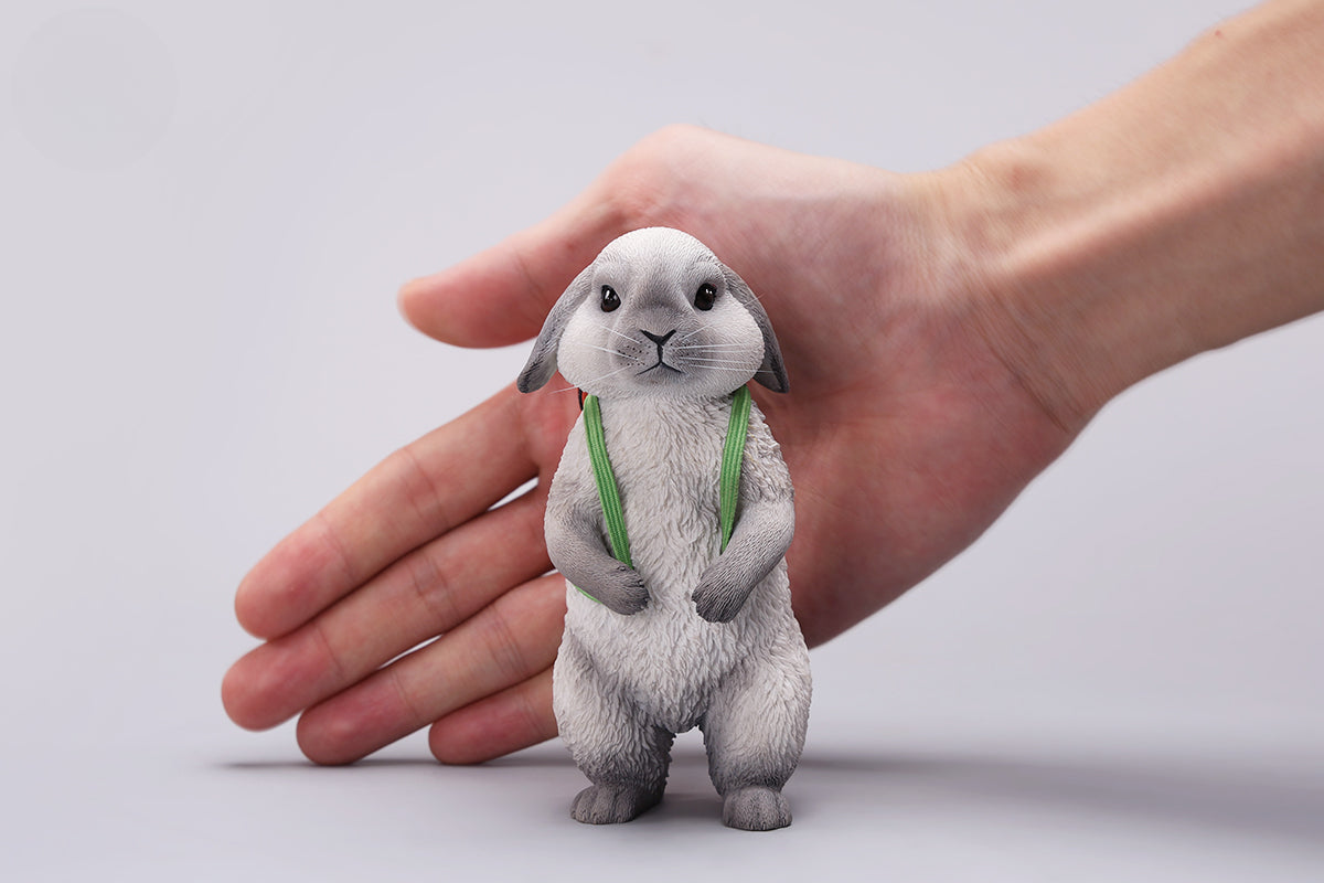 Adorable 1/4 scale American Lop Rabbit figurine with a removable carrot backpack, hand-painted with high detail. Perfect for animal lovers and collectors, showcasing the rabbit’s playful nature and lifelike texture. Ideal for display on shelves or as a gift.