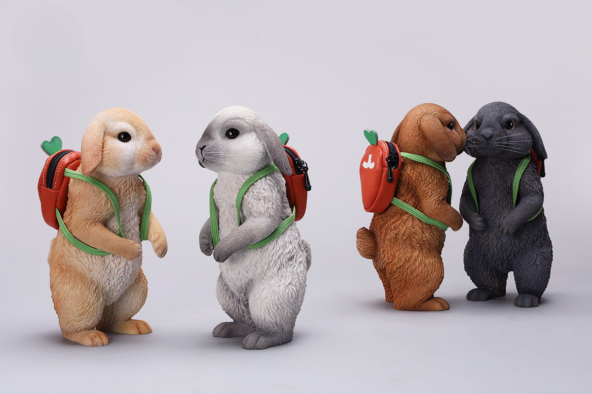 Adorable 1/4 scale American Lop Rabbit figurine with a removable carrot backpack, hand-painted with high detail. Perfect for animal lovers and collectors, showcasing the rabbit’s playful nature and lifelike texture. Ideal for display on shelves or as a gift.