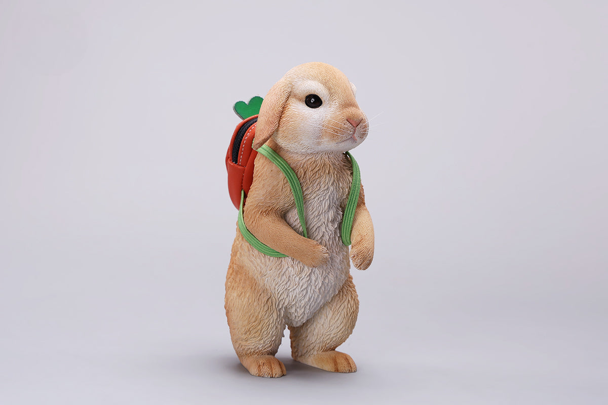 Adorable 1/4 scale American Lop Rabbit figurine with a removable carrot backpack, hand-painted with high detail. Perfect for animal lovers and collectors, showcasing the rabbit’s playful nature and lifelike texture. Ideal for display on shelves or as a gift.