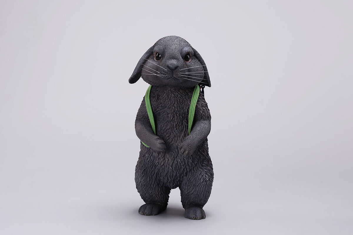 Adorable 1/4 scale American Lop Rabbit figurine with a removable carrot backpack, hand-painted with high detail. Perfect for animal lovers and collectors, showcasing the rabbit’s playful nature and lifelike texture. Ideal for display on shelves or as a gift.