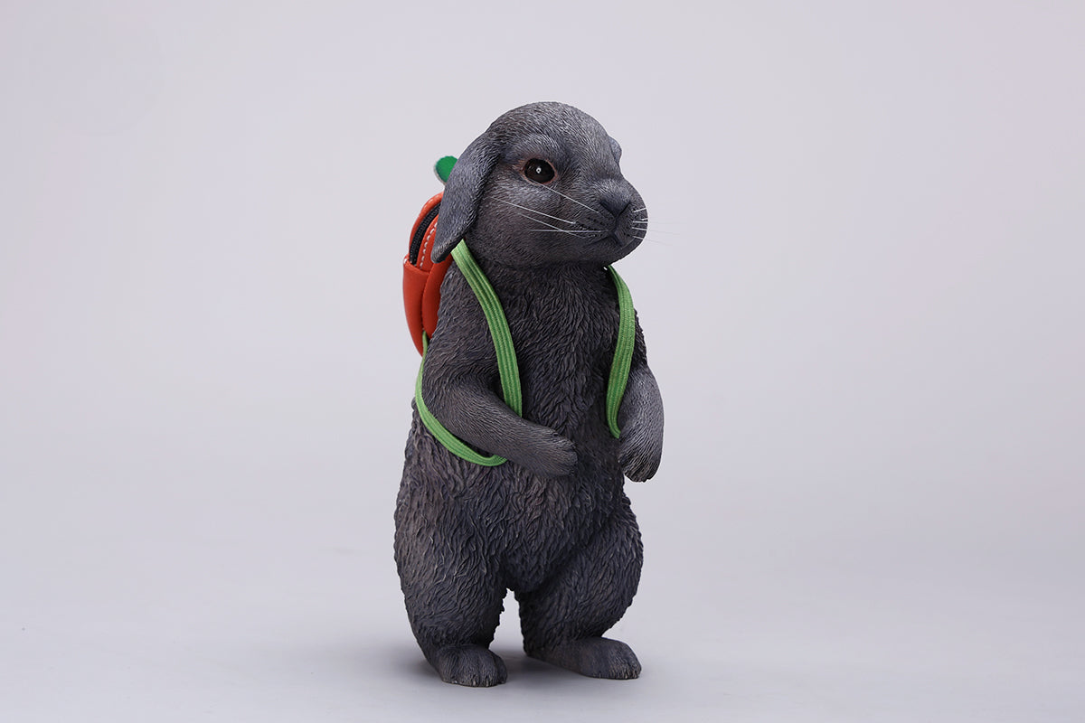 Adorable 1/4 scale American Lop Rabbit figurine with a removable carrot backpack, hand-painted with high detail. Perfect for animal lovers and collectors, showcasing the rabbit’s playful nature and lifelike texture. Ideal for display on shelves or as a gift.