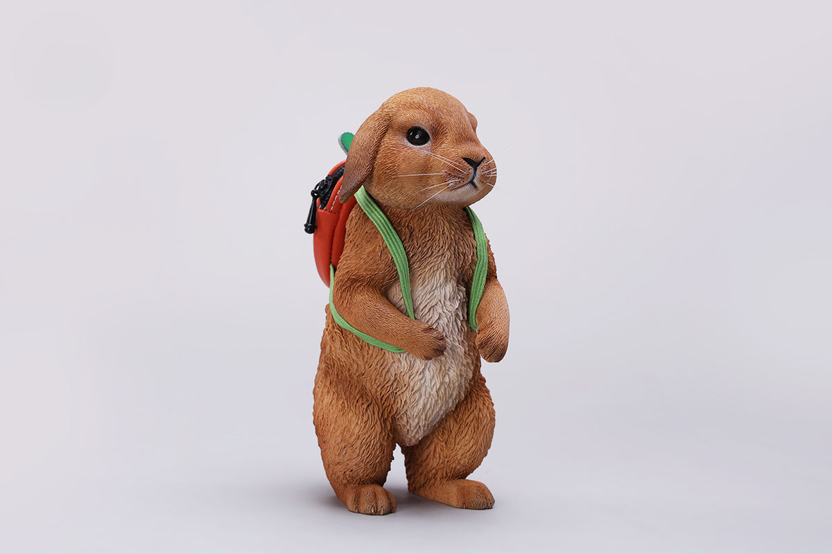 Adorable 1/4 scale American Lop Rabbit figurine with a removable carrot backpack, hand-painted with high detail. Perfect for animal lovers and collectors, showcasing the rabbit’s playful nature and lifelike texture. Ideal for display on shelves or as a gift.