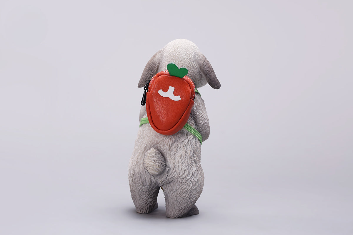 Adorable 1/4 scale American Lop Rabbit figurine with a removable carrot backpack, hand-painted with high detail. Perfect for animal lovers and collectors, showcasing the rabbit’s playful nature and lifelike texture. Ideal for display on shelves or as a gift.
