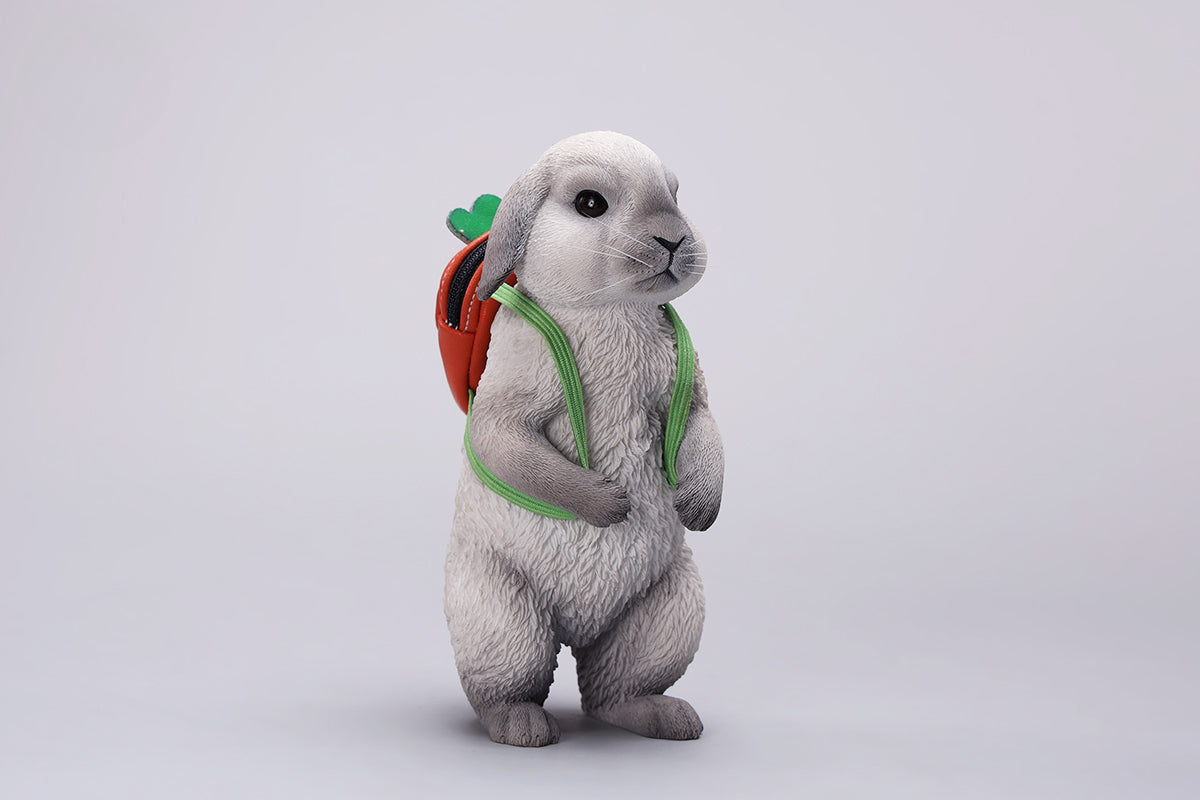 Adorable 1/4 scale American Lop Rabbit figurine with a removable carrot backpack, hand-painted with high detail. Perfect for animal lovers and collectors, showcasing the rabbit’s playful nature and lifelike texture. Ideal for display on shelves or as a gift.