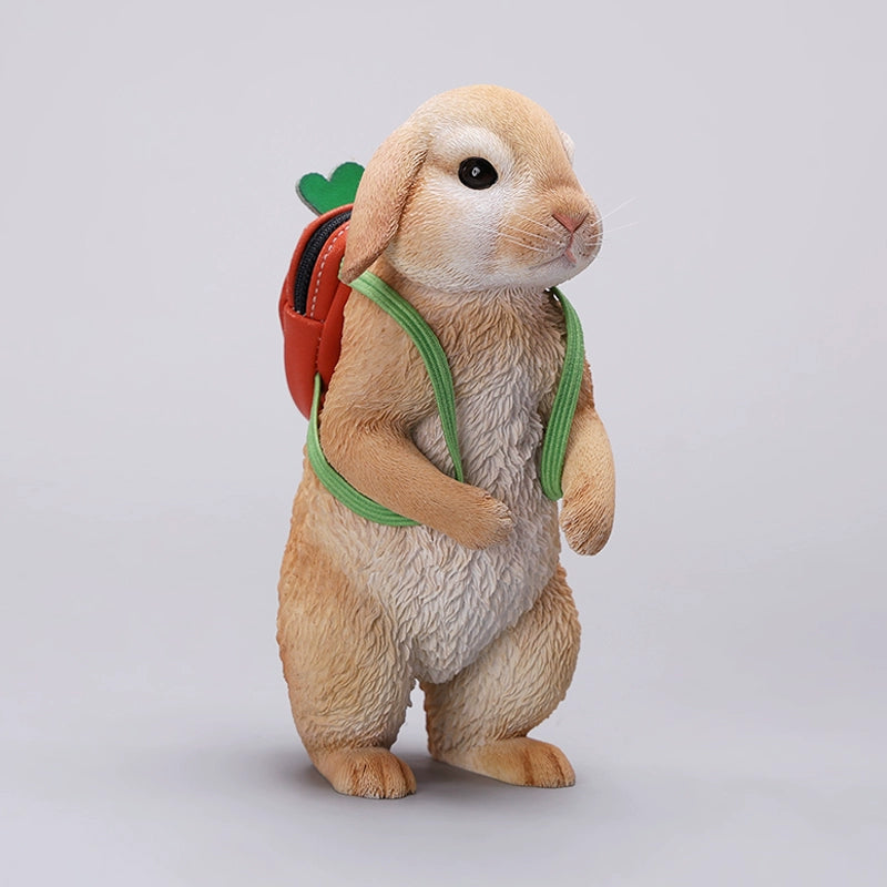 Adorable 1/4 scale American Lop Rabbit figurine with a removable carrot backpack, hand-painted with high detail. Perfect for animal lovers and collectors, showcasing the rabbit’s playful nature and lifelike texture. Ideal for display on shelves or as a gift.