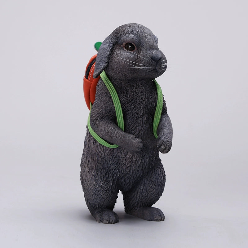 Adorable 1/4 scale American Lop Rabbit figurine with a removable carrot backpack, hand-painted with high detail. Perfect for animal lovers and collectors, showcasing the rabbit’s playful nature and lifelike texture. Ideal for display on shelves or as a gift.