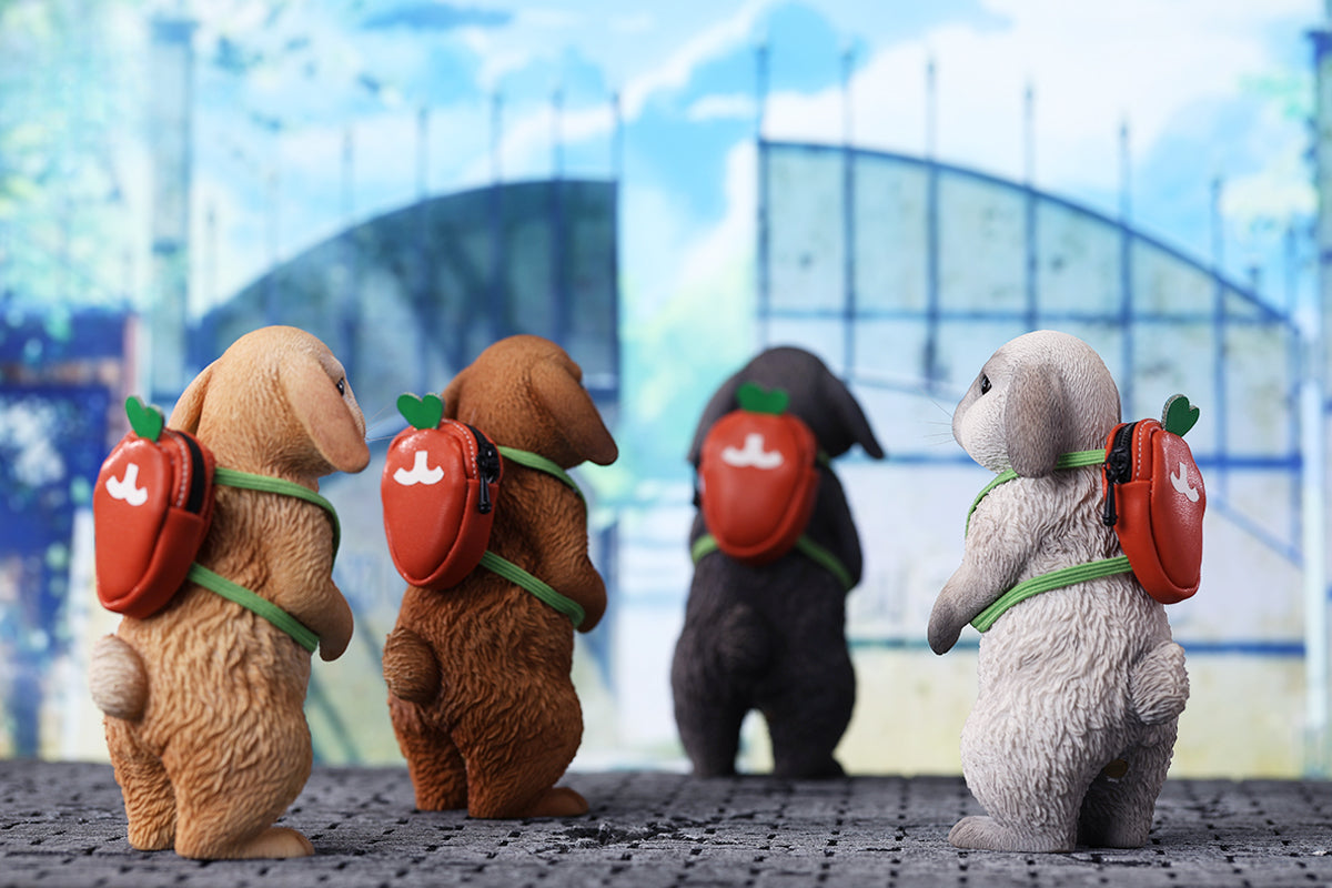 Adorable 1/4 scale American Lop Rabbit figurine with a removable carrot backpack, hand-painted with high detail. Perfect for animal lovers and collectors, showcasing the rabbit’s playful nature and lifelike texture. Ideal for display on shelves or as a gift.