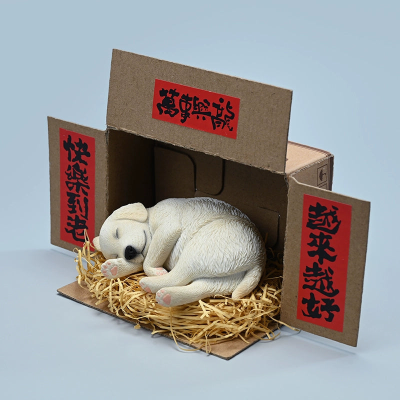 A realistic and finely detailed 1/4 scale model of a Labrador dog in a sleeping position, displayed with traditional Chinese decorations in the background. The model showcases the Labrador in various coat colors, lying peacefully on a bed of straw, with intricate textures capturing the essence of the dog's fur and serene expression.