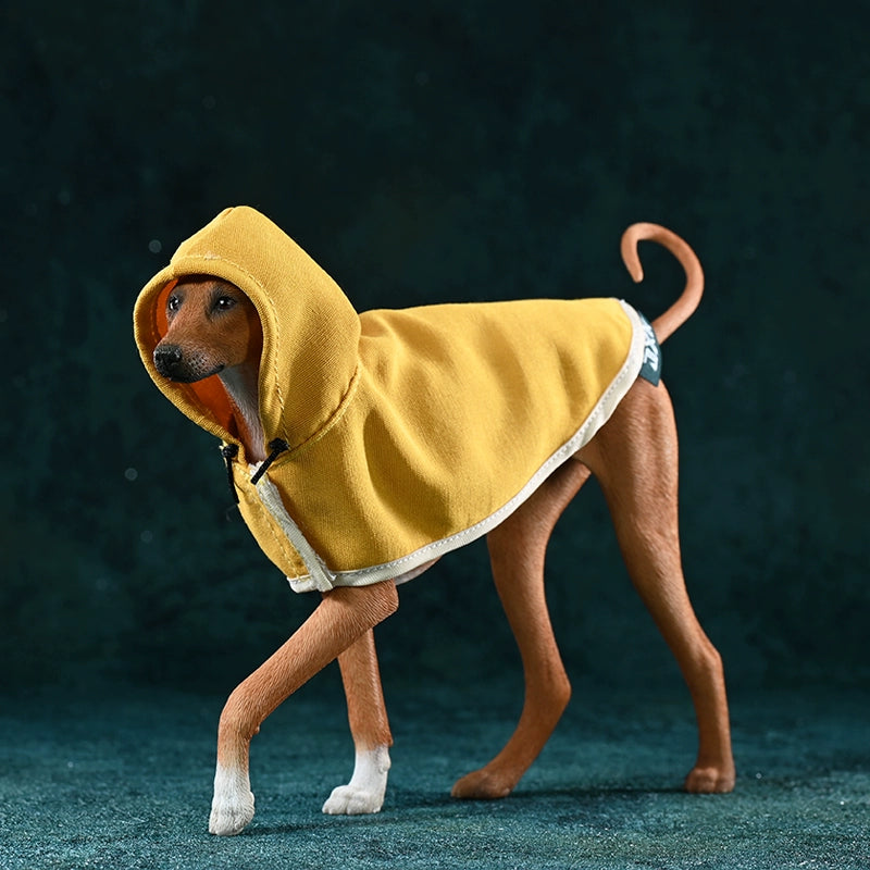 A 1/6 scale model of an Azawakh dog wearing a yellow cape, showcasing a stylish and protective outfit. The dog has a brown coat and a sleek, slender physique.