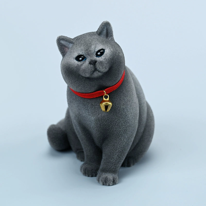 A set of four 1/6 scale British Short-haired Cat models in various fur colors, sitting on a wooden bench. Each cat wears a red collar with a small golden bell, capturing their lifelike and charming expressions. Perfect for collectors and cat enthusiasts.