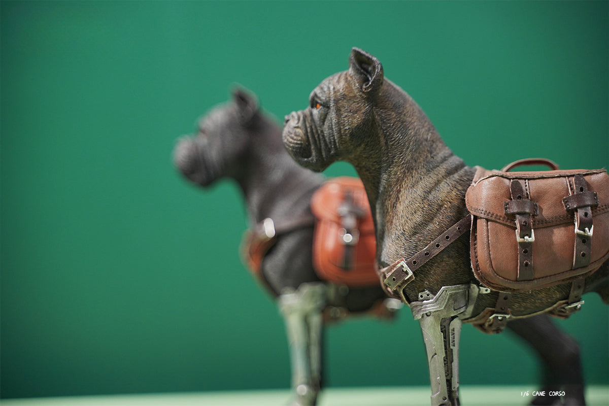 Two 1/6 scale models of dogs equipped with brown leather saddlebags and mechanical prosthetic legs. The models feature detailed and realistic designs, showcasing a mix of rugged and futuristic elements.