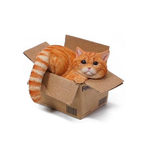 A collection of four 1/6 scale models of cats, each in a different cardboard delivery box. The models feature cats with various fur patterns and colors, including orange tabby, calico, silver tabby, and grey. Each cat is depicted in a relaxed pose, comfortably nestled in the box.