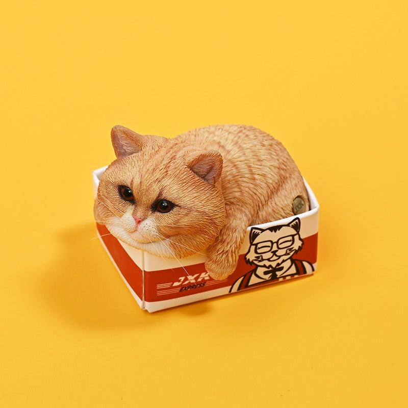 A collection of four 1/6 scale cat models, each resting in a small delivery box with distinct fur colors and patterns. The cats are displayed against a yellow background, showcasing their adorable and relaxed poses.