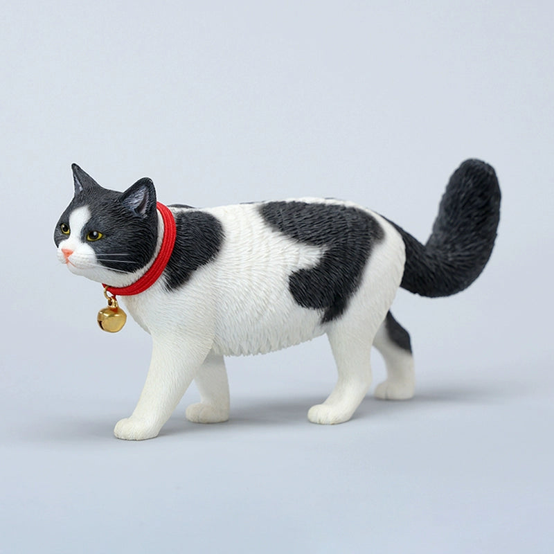 A beautifully crafted 1/6 scale model of a Chinese Felis Catus Cat, showcasing intricate details and a lifelike appearance. The cat model is posed elegantly, wearing a red collar with a bell, exuding charm and character. This figurine is perfect for cat enthusiasts and collectors, adding a touch of elegance and realism to any collection.