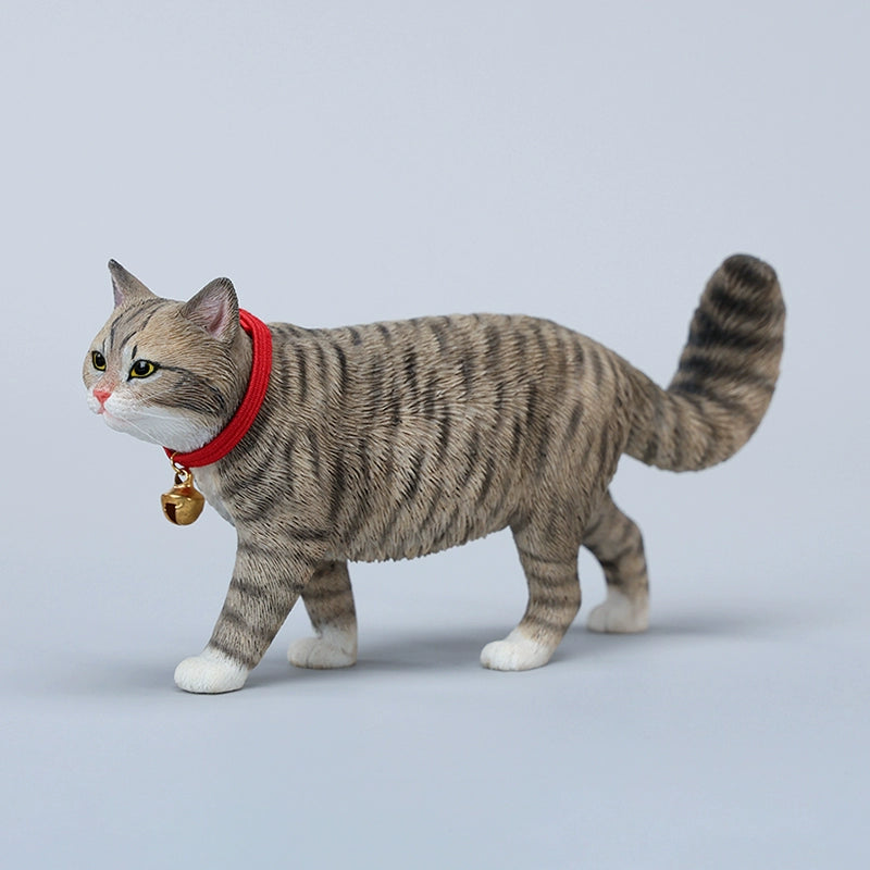 A beautifully crafted 1/6 scale model of a Chinese Felis Catus Cat, showcasing intricate details and a lifelike appearance. The cat model is posed elegantly, wearing a red collar with a bell, exuding charm and character. This figurine is perfect for cat enthusiasts and collectors, adding a touch of elegance and realism to any collection.