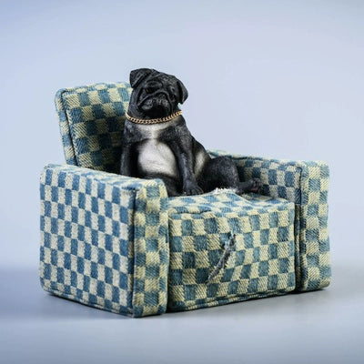 "A set of four 1/6 scale Pug dog models in different poses, sitting on a patterned blue armchair, showcasing a relaxed and decadent style."