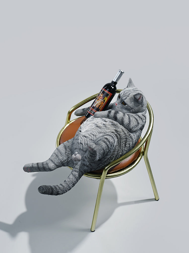 A 1/6 scale figurine of an orange tabby cat lounging on a chair with a bottle, portraying a humorous 'drunk' pose.