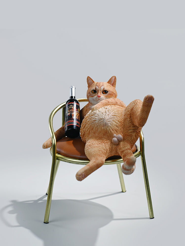 A 1/6 scale figurine of an orange tabby cat lounging on a chair with a bottle, portraying a humorous 'drunk' pose.