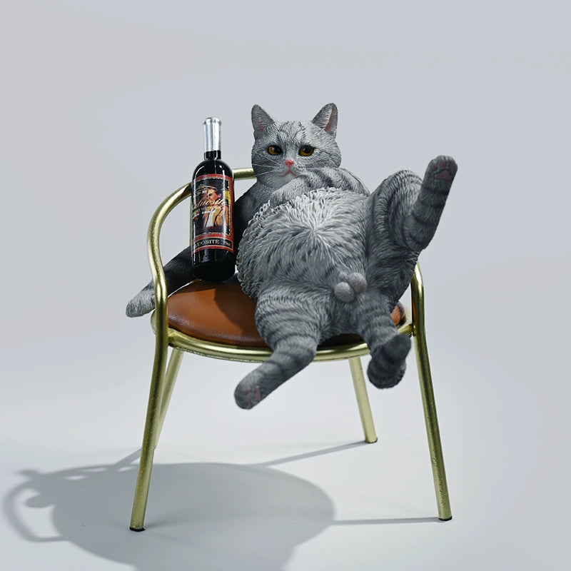 A 1/6 scale figurine of an orange tabby cat lounging on a chair with a bottle, portraying a humorous 'drunk' pose.