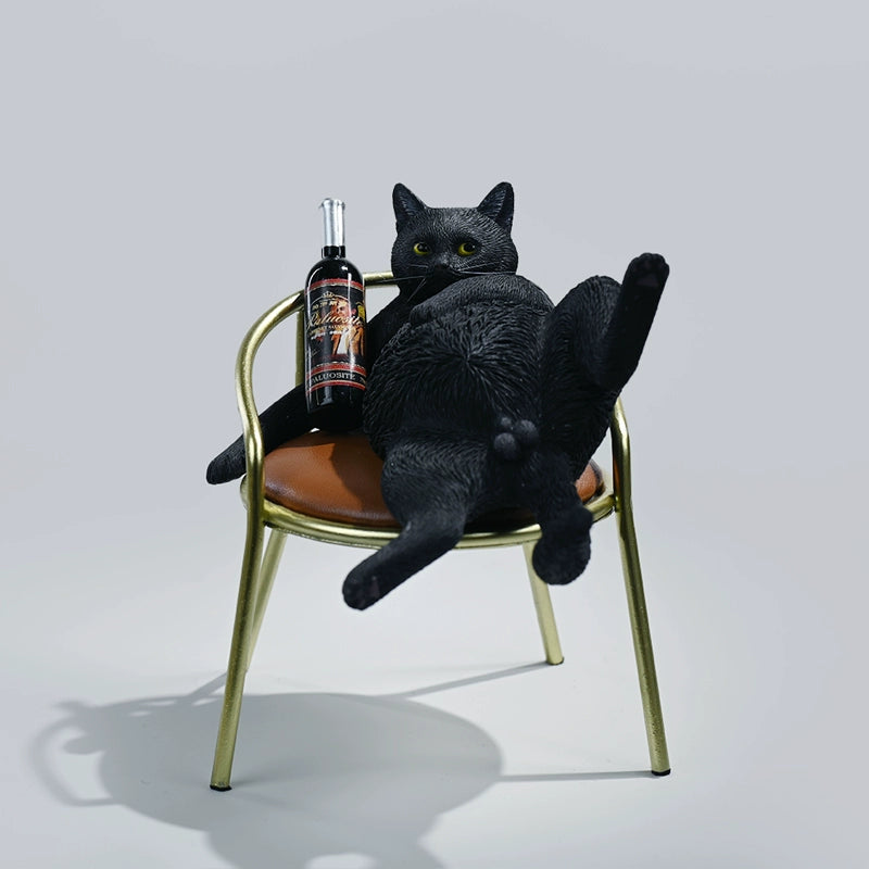 A 1/6 scale figurine of an orange tabby cat lounging on a chair with a bottle, portraying a humorous 'drunk' pose.