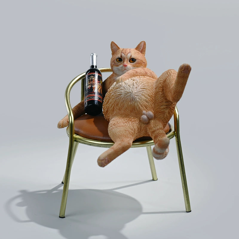 A 1/6 scale figurine of an orange tabby cat lounging on a chair with a bottle, portraying a humorous 'drunk' pose.