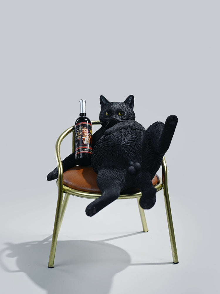 A 1/6 scale figurine of an orange tabby cat lounging on a chair with a bottle, portraying a humorous 'drunk' pose.