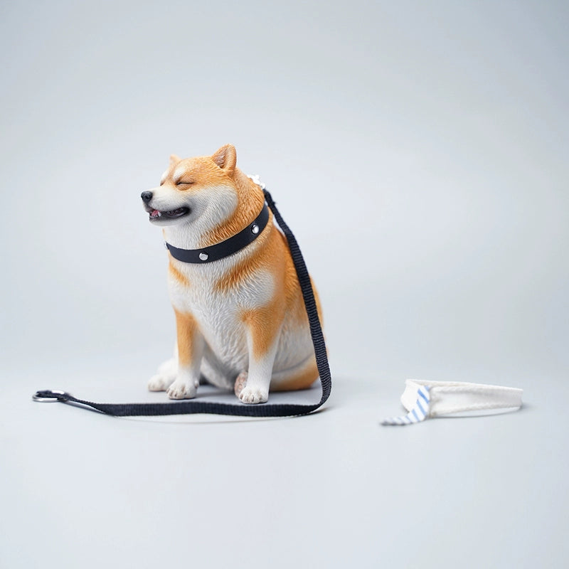 Three 1/6 scale Fat Shiba Lun Dog Models, each wearing a blue and white striped tie, sitting in a row on a green surface with their reflections visible in the water below. These figurines feature realistic details and cheerful expressions, perfect for collectors and dog enthusiasts.