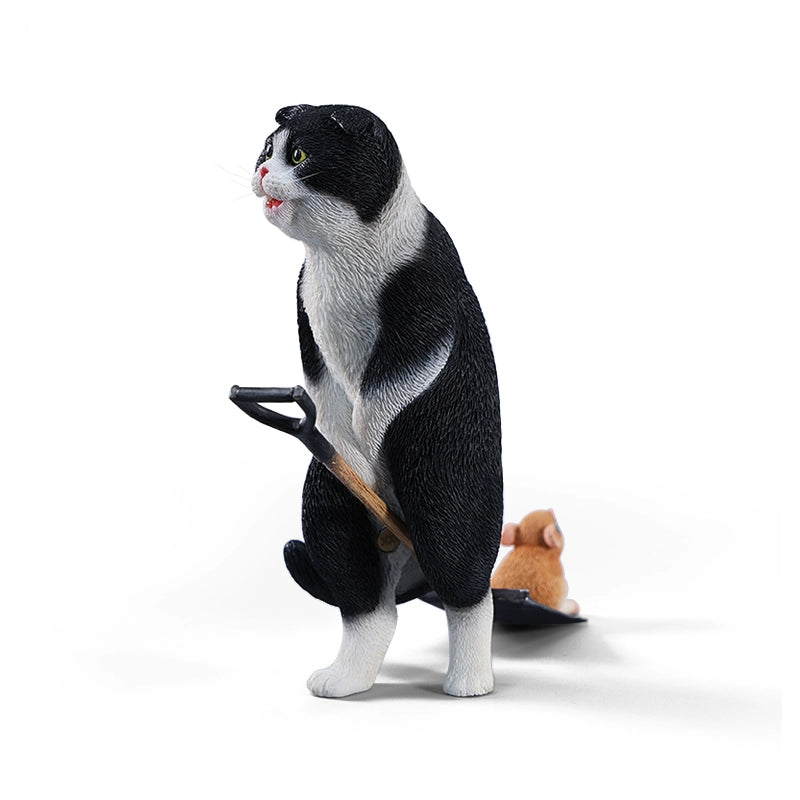 A realistic 1/6 scale folded eared cat figurine with a mouse on a spade, handcrafted from resin and hand-painted to capture lifelike details.