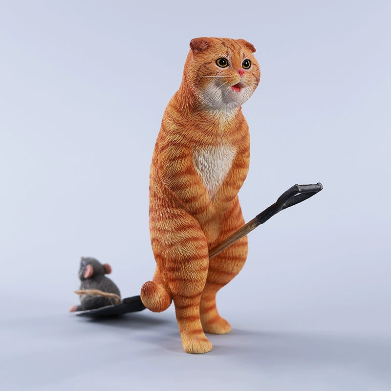 A realistic 1/6 scale folded eared cat figurine with a mouse on a spade, handcrafted from resin and hand-painted to capture lifelike details.