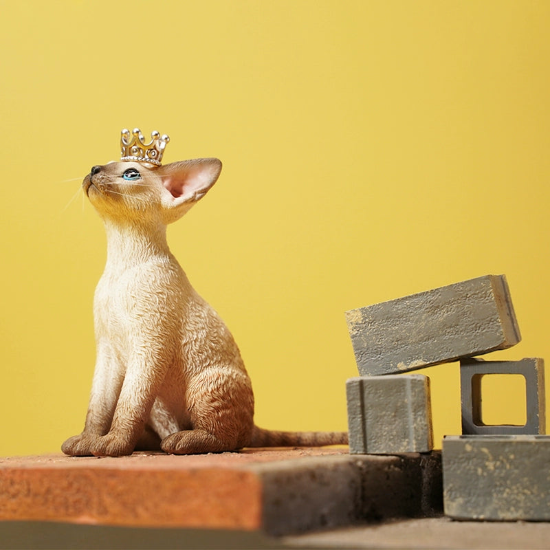 A realistic 1/6 scale German Curly Princess Cat model featuring an orange tabby cat with a crown, elegantly posed among miniature blocks. This figurine captures the regal essence of the cat, making it a perfect collectible for cat enthusiasts and home decor.