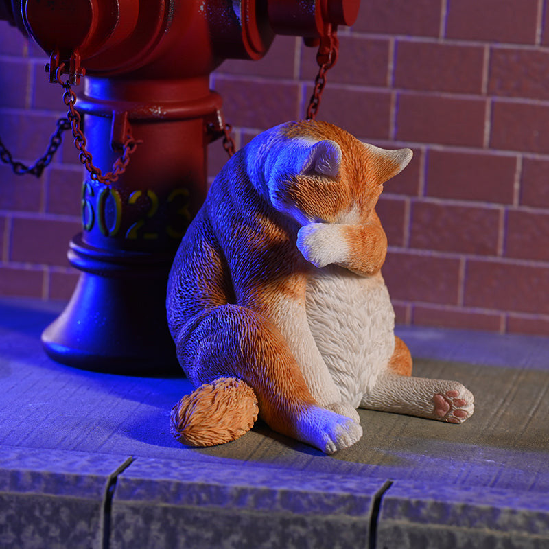 A 1/6 scale model of a lazy cat in various poses, including a ginger cat lounging on a blue bean bag. This highly detailed figurine captures the whimsical and relaxed nature of the cat, making it a perfect collectible for cat lovers and miniature enthusiasts.