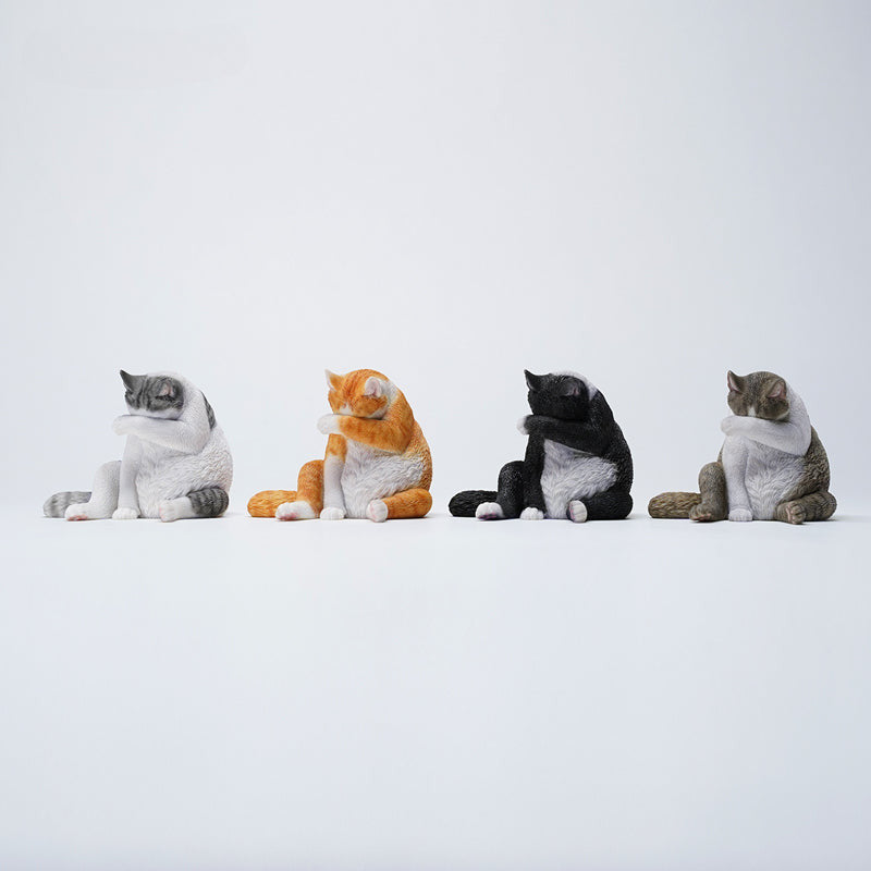 A 1/6 scale model of a lazy cat in various poses, including a ginger cat lounging on a blue bean bag. This highly detailed figurine captures the whimsical and relaxed nature of the cat, making it a perfect collectible for cat lovers and miniature enthusiasts.