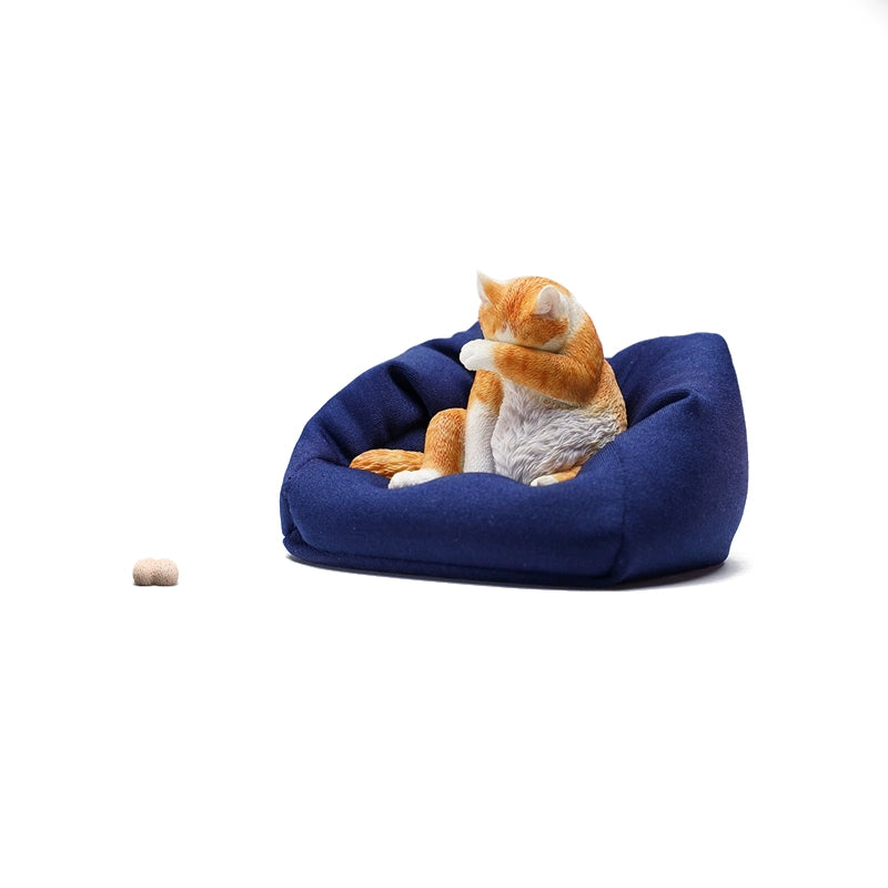 A 1/6 scale model of a lazy cat in various poses, including a ginger cat lounging on a blue bean bag. This highly detailed figurine captures the whimsical and relaxed nature of the cat, making it a perfect collectible for cat lovers and miniature enthusiasts.