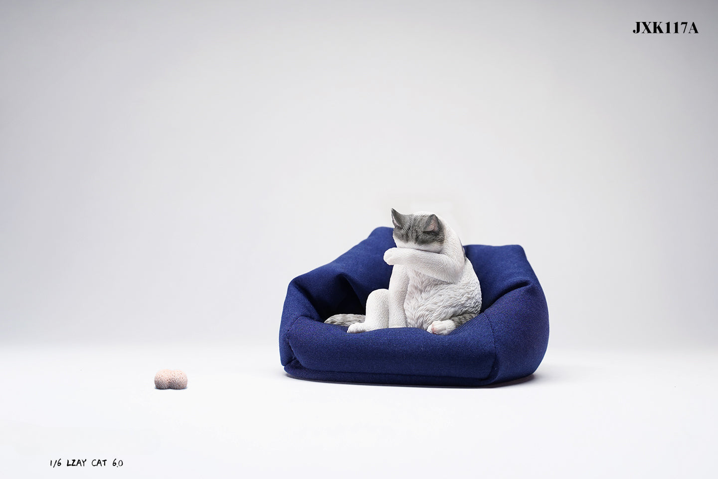 A 1/6 scale model of a lazy cat in various poses, including a ginger cat lounging on a blue bean bag. This highly detailed figurine captures the whimsical and relaxed nature of the cat, making it a perfect collectible for cat lovers and miniature enthusiasts.