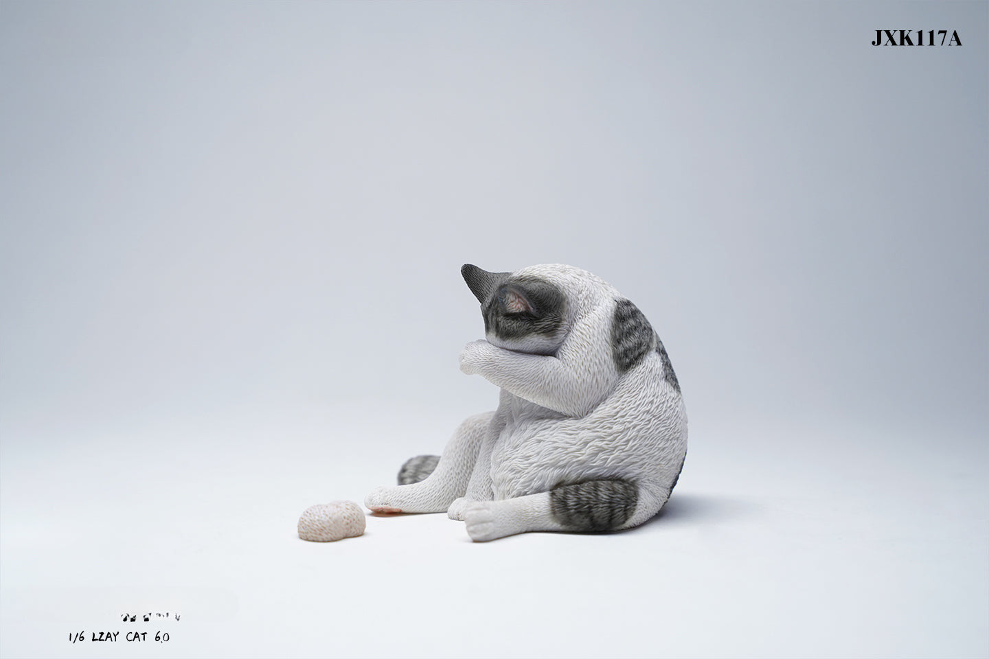 A 1/6 scale model of a lazy cat in various poses, including a ginger cat lounging on a blue bean bag. This highly detailed figurine captures the whimsical and relaxed nature of the cat, making it a perfect collectible for cat lovers and miniature enthusiasts.