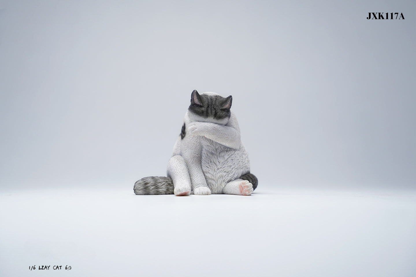 A 1/6 scale model of a lazy cat in various poses, including a ginger cat lounging on a blue bean bag. This highly detailed figurine captures the whimsical and relaxed nature of the cat, making it a perfect collectible for cat lovers and miniature enthusiasts.