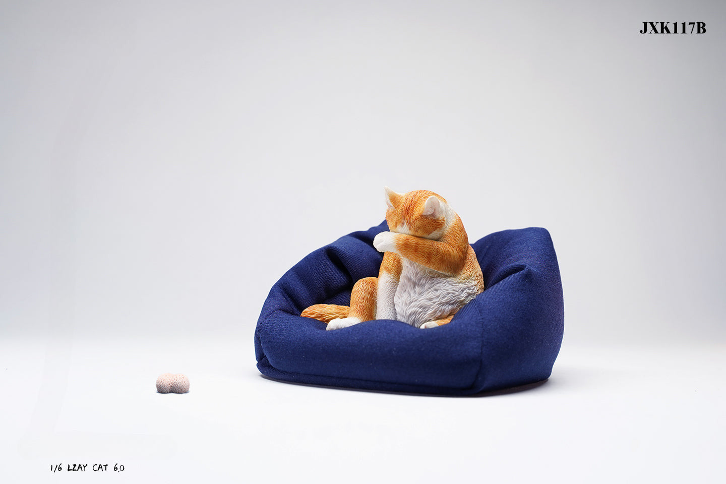 A 1/6 scale model of a lazy cat in various poses, including a ginger cat lounging on a blue bean bag. This highly detailed figurine captures the whimsical and relaxed nature of the cat, making it a perfect collectible for cat lovers and miniature enthusiasts.